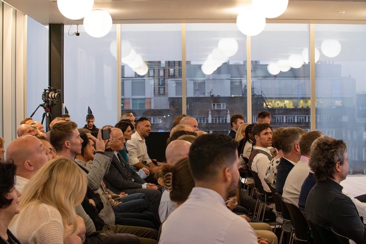 Engaged audience with city skyline view during presentation