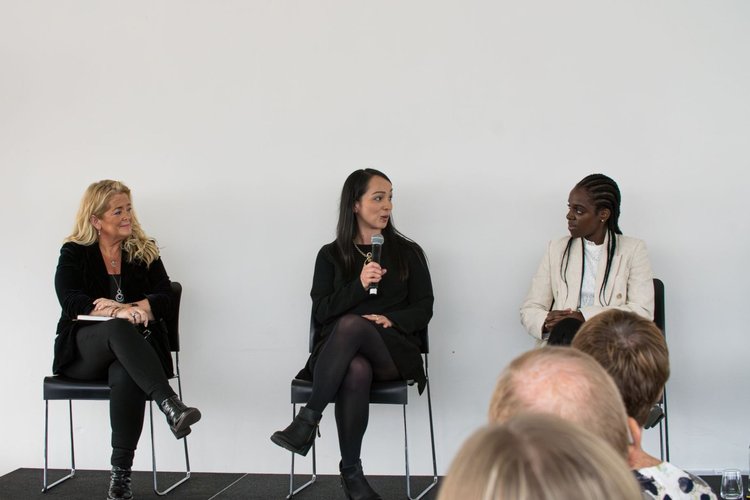 Professional panel discussion with three female speakers