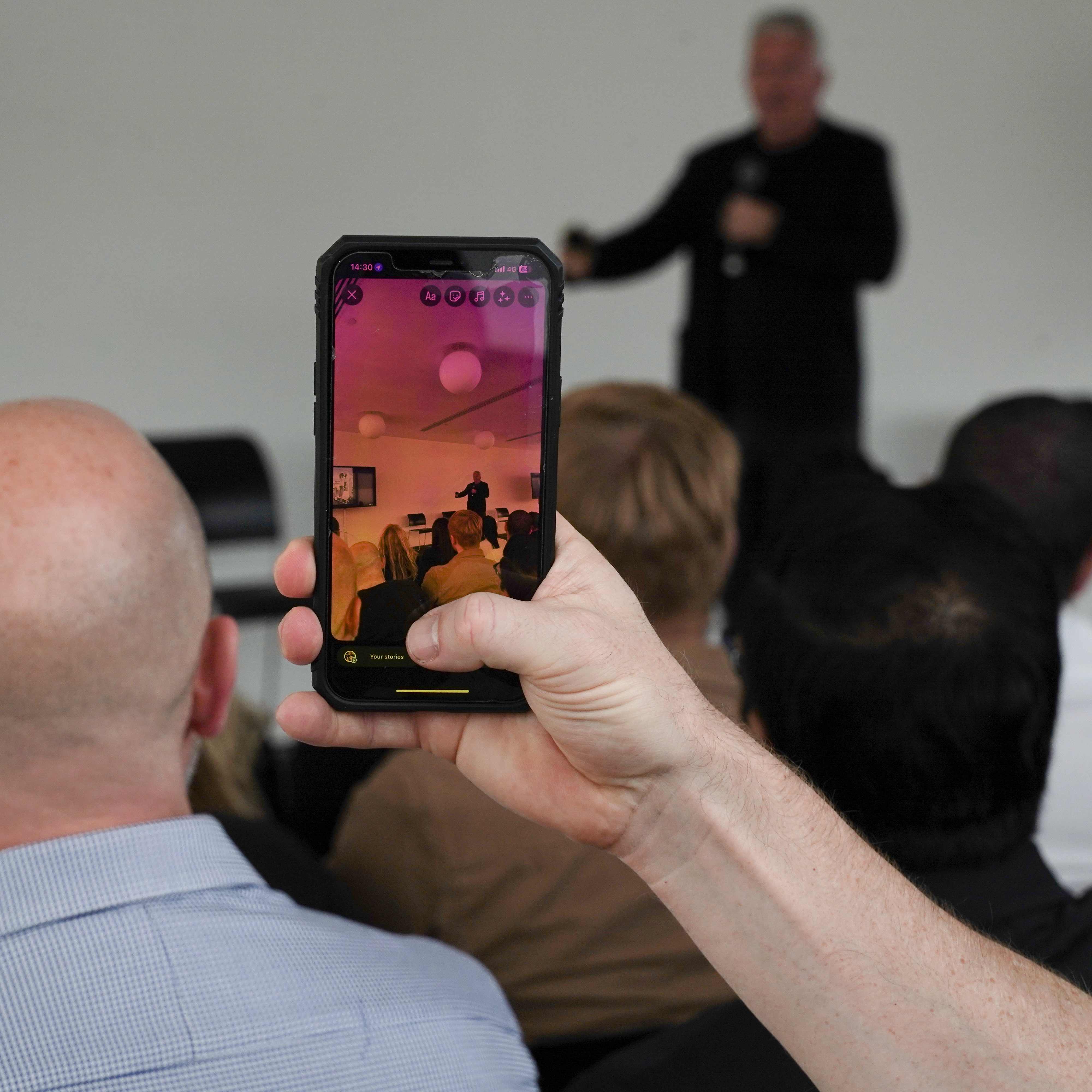 Attendee capturing presentation moment